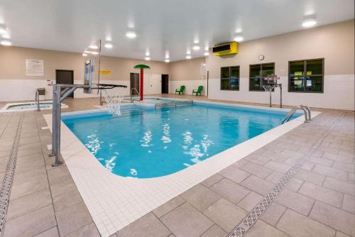 a large swimming pool in a building at Super 8 by Wyndham Winnipeg East MB in Winnipeg