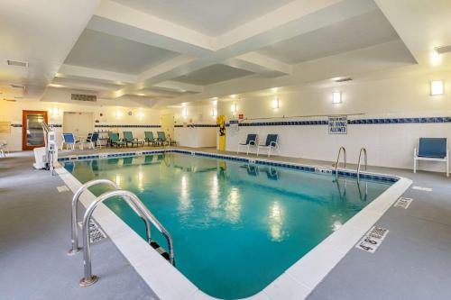 a large swimming pool with blue water in a building at Comfort Inn Louisville Southwest in Louisville