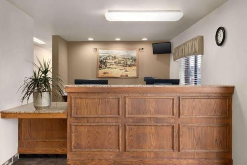 a waiting area of a hospital with a large wooden counter at Baymont by Wyndham Buffalo in Buffalo
