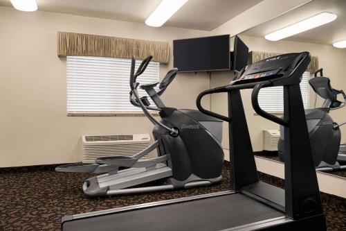 a gym with tread machines in a room at Baymont by Wyndham Buffalo in Buffalo