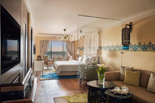 a living room with a couch and a bed in a room at Sofitel Legend Old Cataract in Aswan