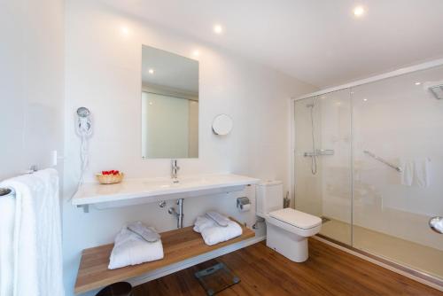 a bathroom with a sink and a toilet and a shower at Aparthotel Ponent Mar in Palmanova