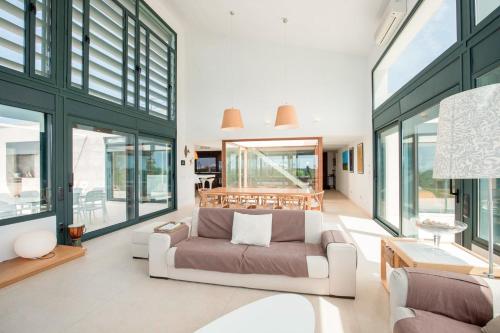 a living room with a couch and some windows at Villa Forma Nou in Mahón