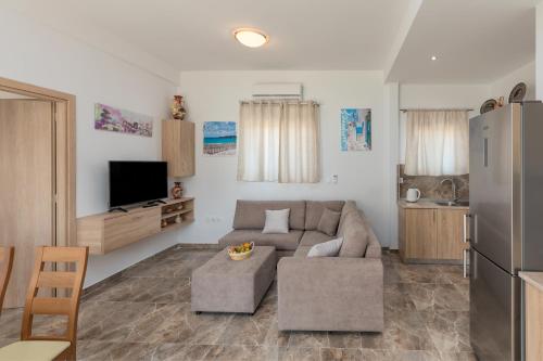 a living room with a couch and a refrigerator at Paradise Garden in Kolimbia