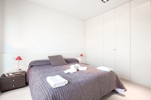 a bedroom with a bed with two towels on it at Villa Forma Nou in Mahón