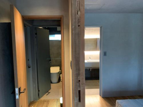 a bathroom with a toilet and a sink in a room at -1日1組限定-犬と泊まれる古民家宿 wanco minca わんこみんか in Minamiawaji