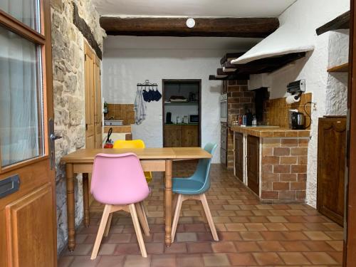 une cuisine avec une table en bois et deux chaises dans l'établissement Au 333, à Bédoin