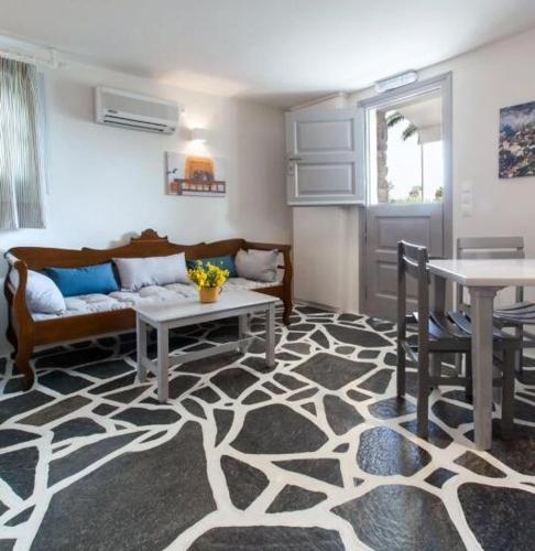 a living room with a couch and a table at Byzantio Beach Suites & Wellness in Agios Sostis