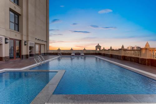 a swimming pool on the roof of a building at Lemon Tree Premier, Dwarka in Dwarka