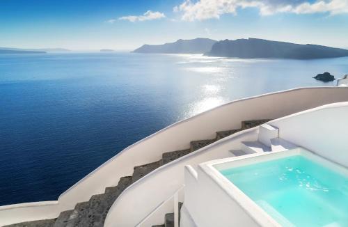 a view of the ocean from the balcony of a cruise ship at White Pearl Villas in Oia