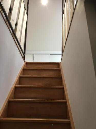 a staircase in an office building with wooden stairs at la Rose sur Meuse in Haybes