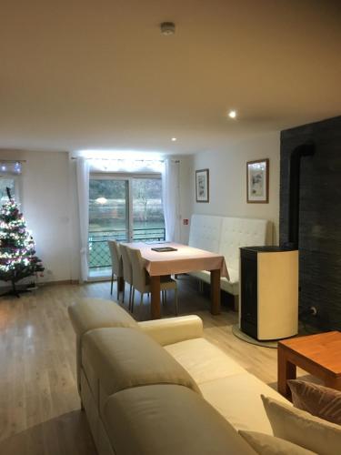 a living room with a couch and a table at la Rose sur Meuse in Haybes
