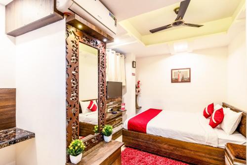 a bedroom with a bed and a mirror at Octave Kings Suites in Bangalore