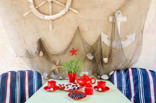 a table with red cups and plates of food on it at Apartment Caceris in Dubrovnik