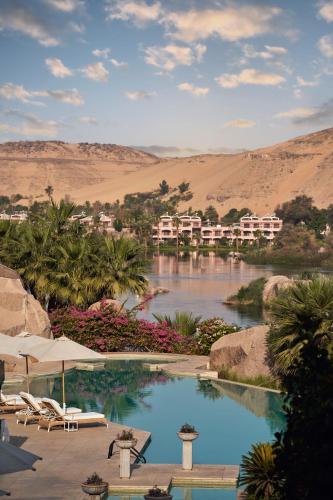 a resort with a swimming pool in the desert at Sofitel Legend Old Cataract in Aswan