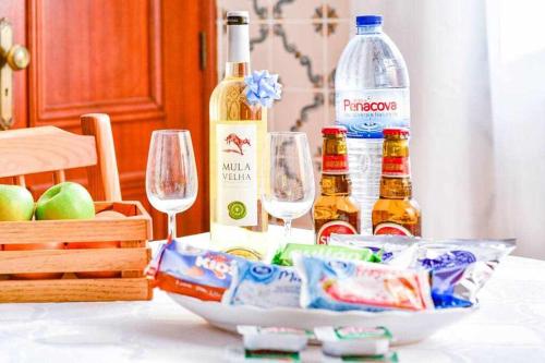 a table with two glasses and bottles of wine at Apartamento Algoz by MTPHomes in Algoz