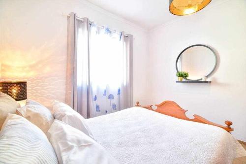 a white bedroom with a bed and a window at Apartamento Algoz by MTPHomes in Algoz