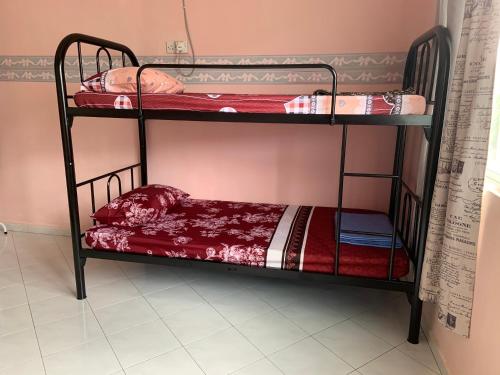 a couple of bunk beds in a room at Pangkor Damai in Pangkor