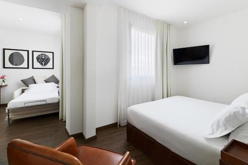Ένα ή περισσότερα κρεβάτια σε δωμάτιο στο Boutique Hotel H10 Montcada