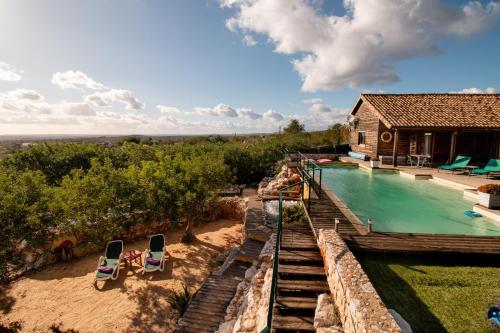 an aerial view of a house with a swimming pool at Chambres d'hôtes Naturistes (Nudiste) "Cabanadelsol" - Adults Only in Monte da Charneca