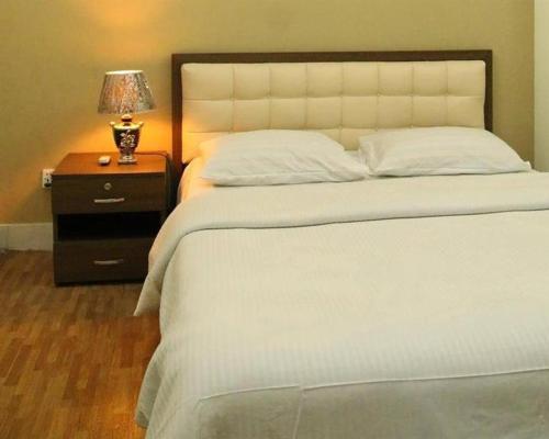 Richmond Hotel Sylhetにあるベッド