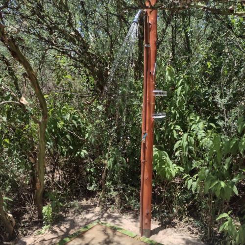a water pump in the middle of a forest at Cosmos Tiny House in San Marcos Sierras
