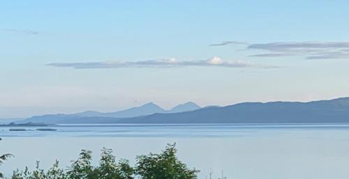 a view of the water with mountains in the distance at Corrie House in Craobh Haven