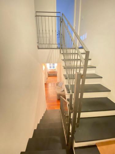 a staircase in a house with a metal railing at Villa Arancia Quiet, Central, Parking and Air Conditioning in Levanto
