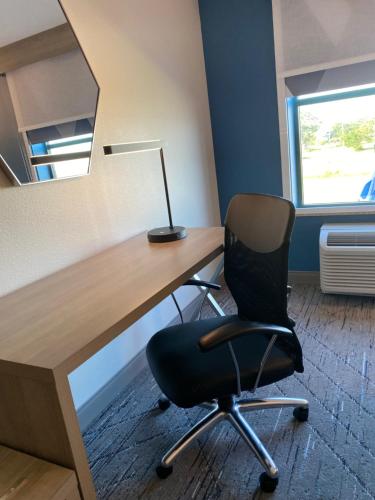 an office with a desk with a chair and a lamp at Holiday Inn Express - Gulfport Beach by IHG in Gulfport