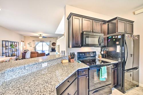 a kitchen with wooden cabinets and a counter top at Modern Poncha Springs Townhome with Mtn Views! in Salida