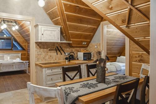 a kitchen and dining room with a table in a cabin at TatrApart in Zakopane