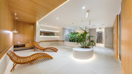 a lobby with two benches and a table and plants at Nexo, Sun & Snow in Puck