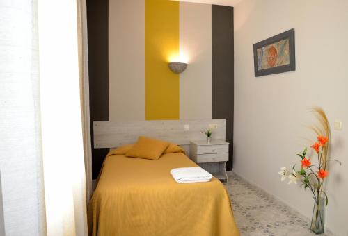 a bedroom with a bed with a yellow blanket at Cuatro Caminos in Piedrabuena
