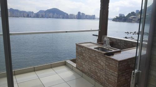 a bathroom with a sink and a view of the water at Sobrado com vista ao mar in São Vicente