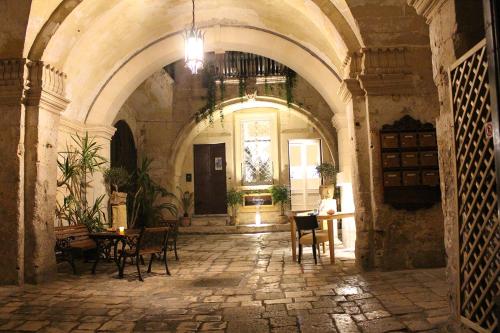 an empty room with chairs and tables in a building at B&B Palazzo Sambiasi in Lecce