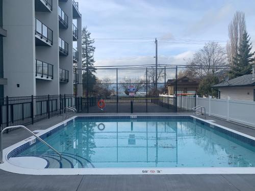 a swimming pool in front of a apartment building at Vita Resort on Lake Okanagan in Vernon