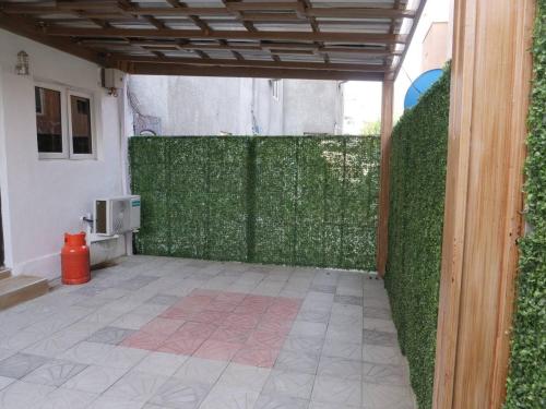 a room with a green wall next to a building at Luxury House - Sleeps 8 & Free Parking in Abuja