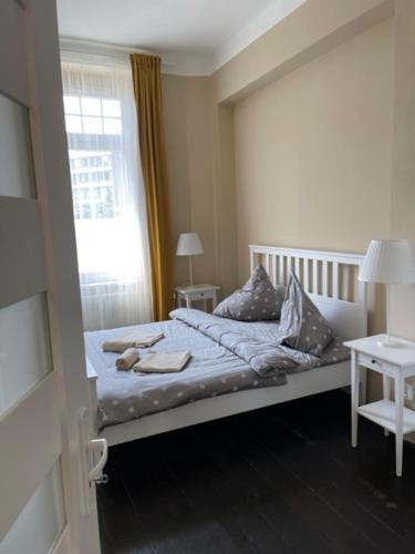a small bedroom with a bed with a window at Apartmán Galerie in Děčín