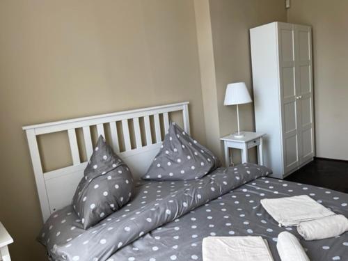 a bedroom with a bed with pillows on it at Apartmán Galerie in Děčín