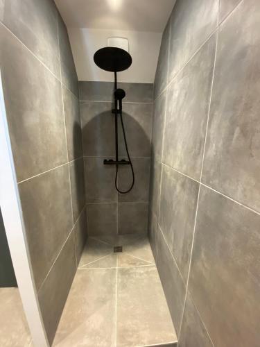 a bathroom with a shower with a light on the wall at Appartement neuf Méribel hyper centre accès pistes in Méribel