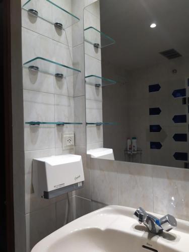 a bathroom with a sink and a mirror at Apartamento de montaña "Nueva Canfranc" in Canfranc-Estación