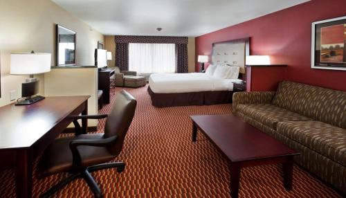 a hotel room with a bed and a couch at Holiday Inn Express and Suites Great Falls by IHG in Great Falls