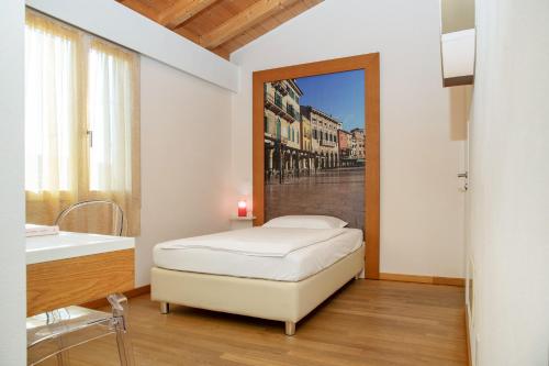 a bedroom with a bed and a sink and a mirror at Via Verdi B&B in Vago