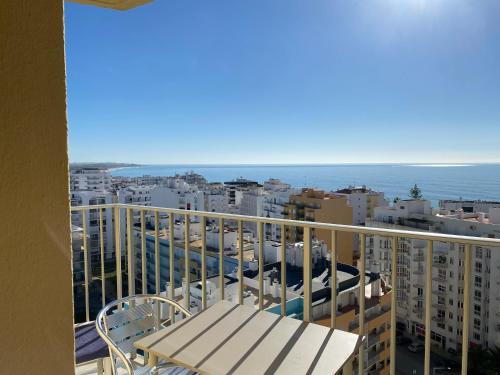balcón con banco y vistas al océano en Armação de Pêra, en Armação de Pêra