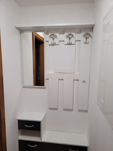 a white bathroom with a sink and a mirror at Casa Luca in Mezzana