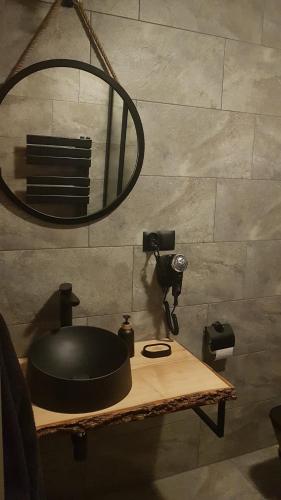 a room with a table with a pot and a mirror at Domek Przekolec in Szaflary