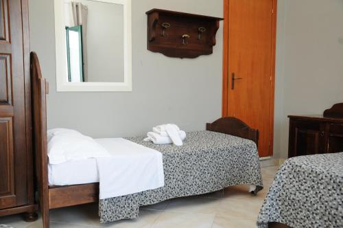 a bedroom with two beds and a mirror at Hotel Sannita in Casoria