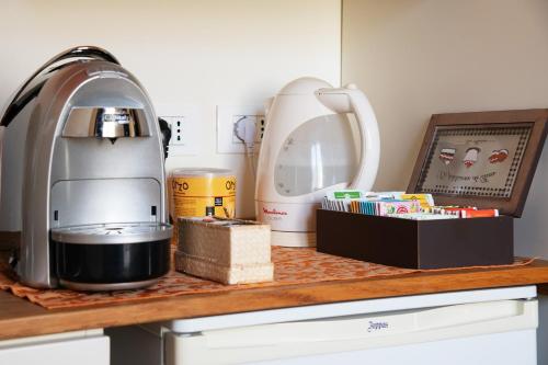 a kitchen counter with a mixer and a box at Via Verdi B&B in Vago
