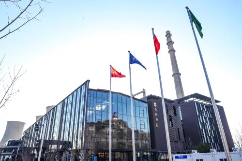 a building with flags in front of it at Shangri-La Shougang Park, Beijing in Beijing