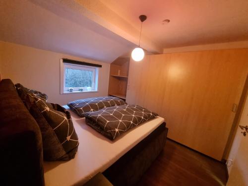 a bedroom with a bed and a couch and a window at Ferienwohnung Schneeberg in Stryck